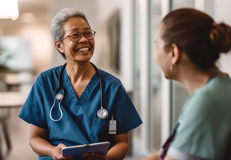 Candid shot of two nurses laughing and talking in a hospital, showcasing positivity, camaraderie among healthcare workers, generative ai